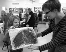 PICTURE PERFECT: Georgia Murphy shows off her creativity to TIPS volunteer Heather Gordon during the after school club.